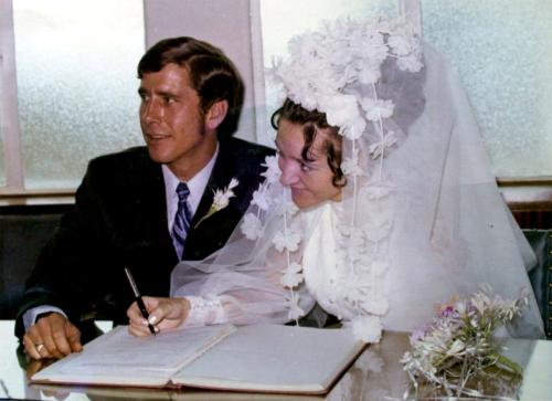 The couple sign their marriage form